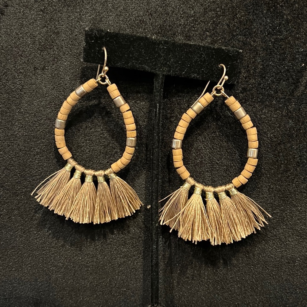 Tan beaded fringe earrings.